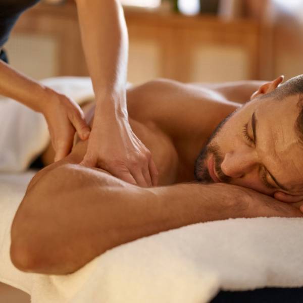 Relaxed man enjoying massage in spa