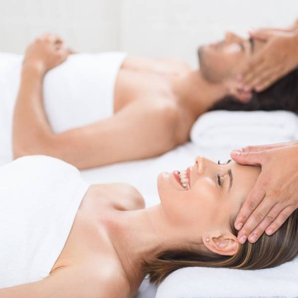 Getting rid of our stress. Cropped shot of husband and wife lying together on massage tables and receiving head massages